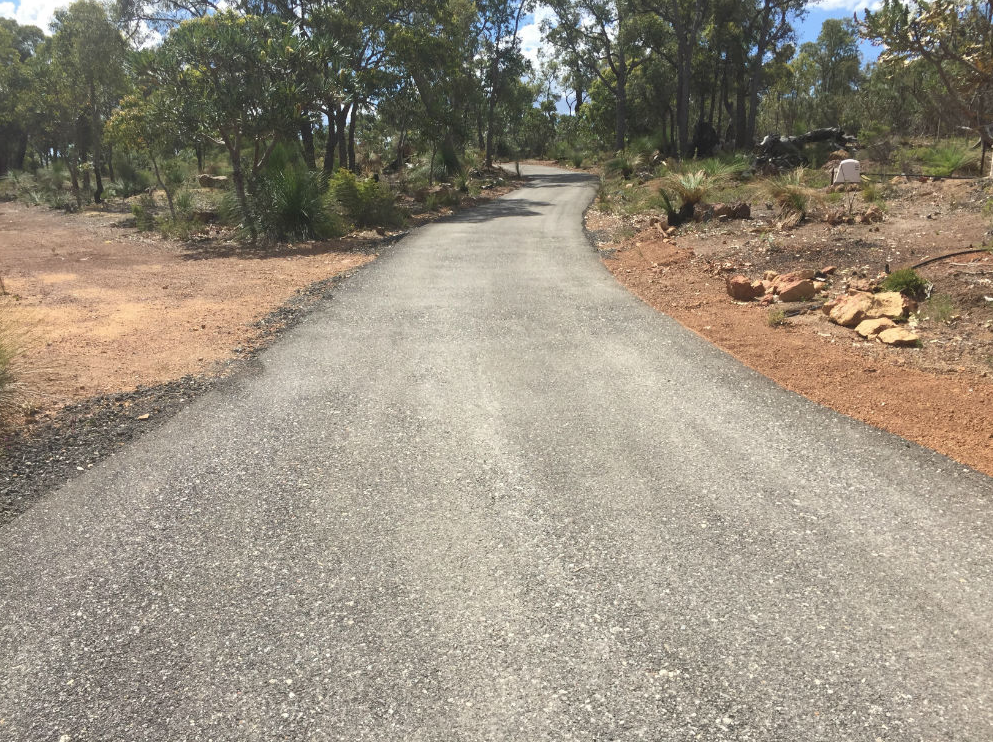 This is a photo of a hot spray & seal bitumen driveway which is in the process of being installed by Footscray Road Tech