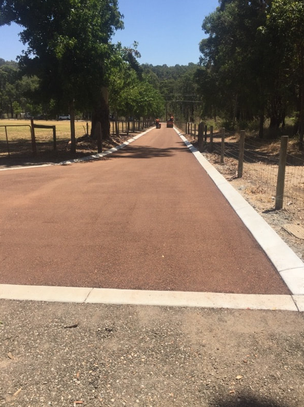 This is a photo of a hot spray & seal bitumen roadway which is in the process of being installed by Footscray Road Tech